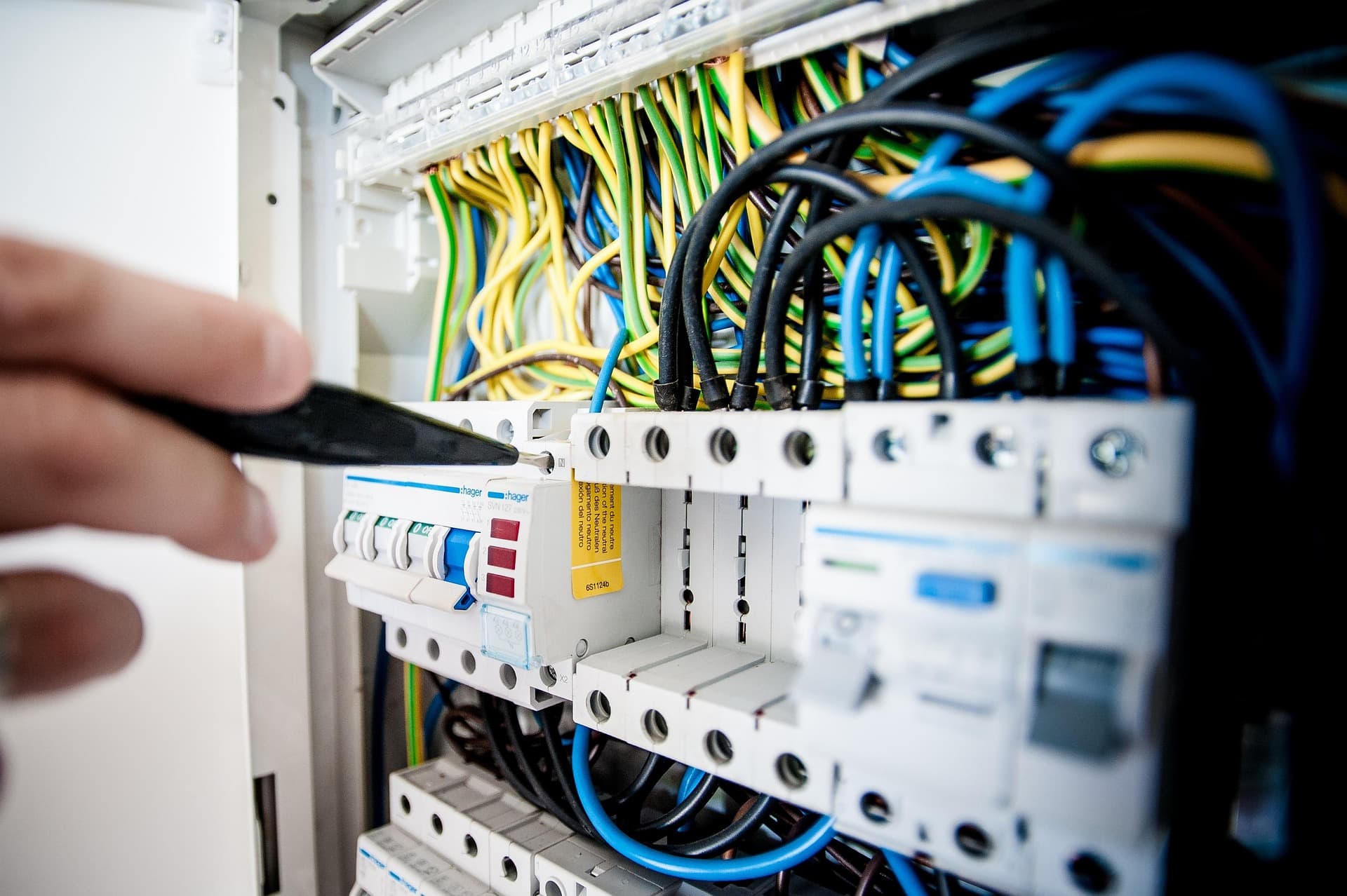 Electrical control panel wiring with circuit breakers and colored wire bundles