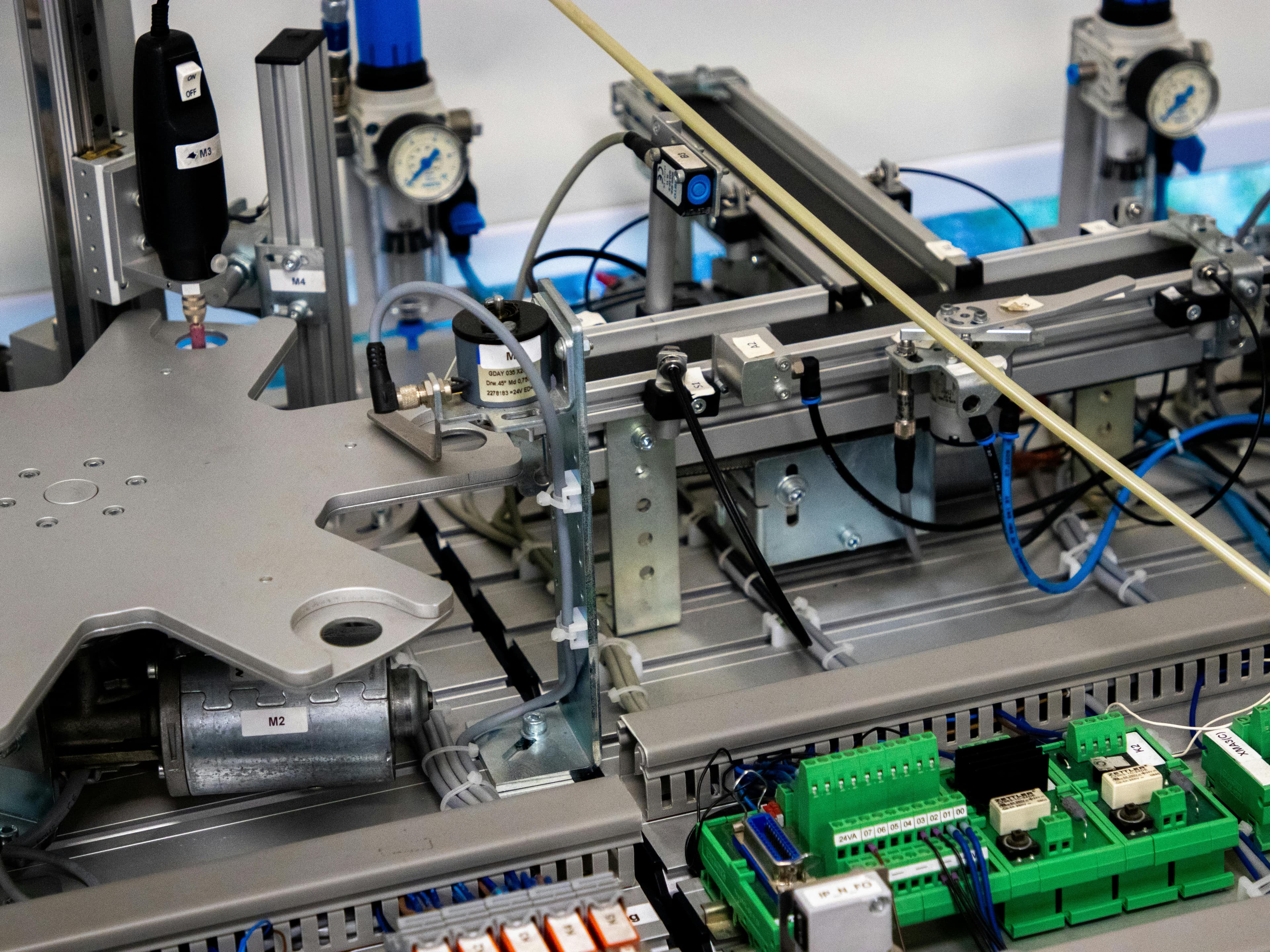 Industrial automation workcell with PLC I/O modules and pneumatic actuators